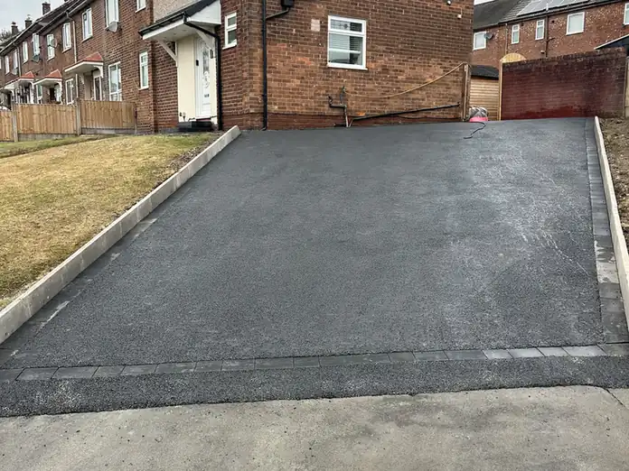 Tarmac driveway on an end terrace with block edging to the lawn - tarmac driveways in Middleton